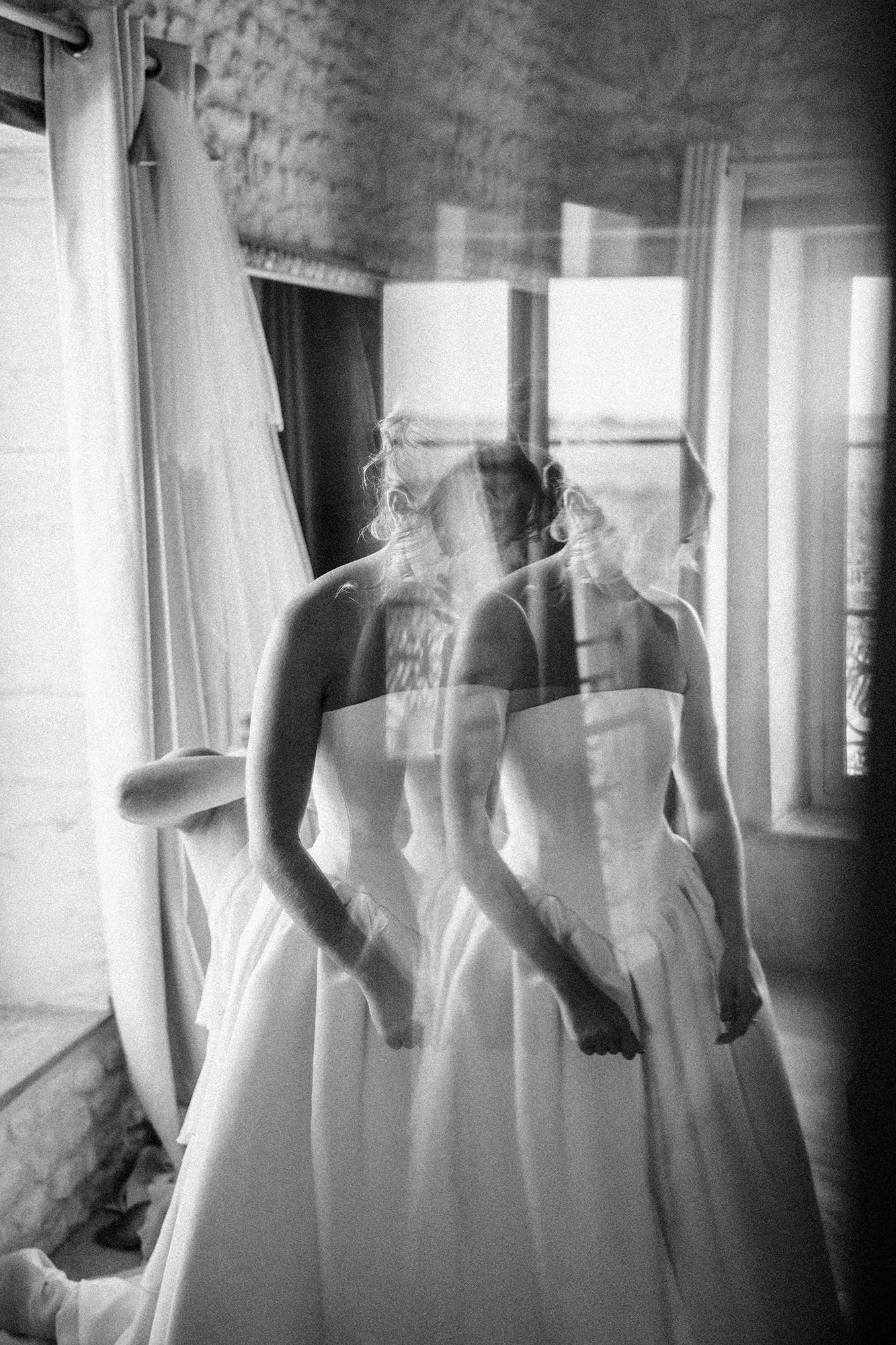 Black and white reflected portrait of a bride getting ready in France