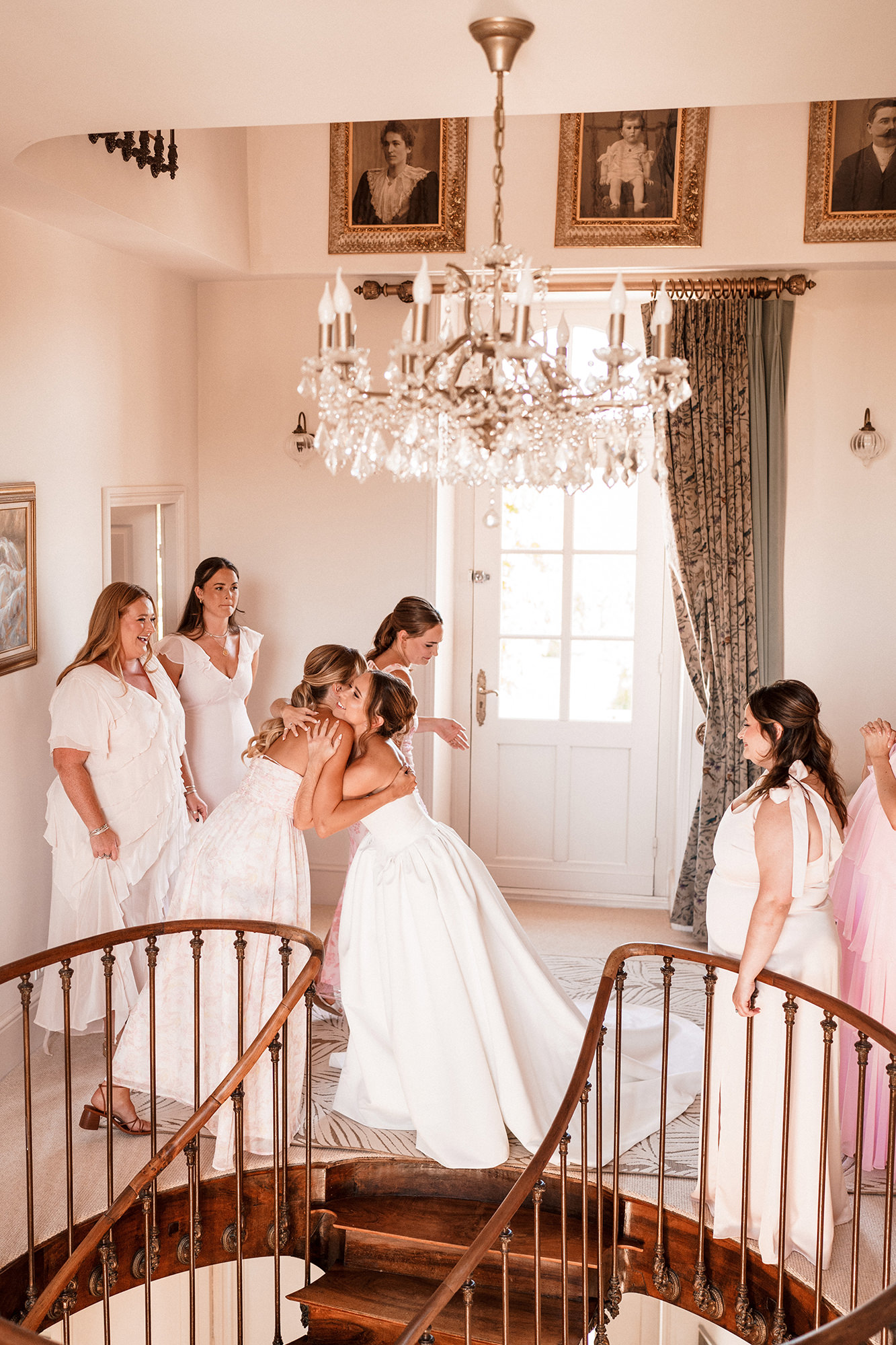 Bride hugging a bridesmaid during wedding preparations in France