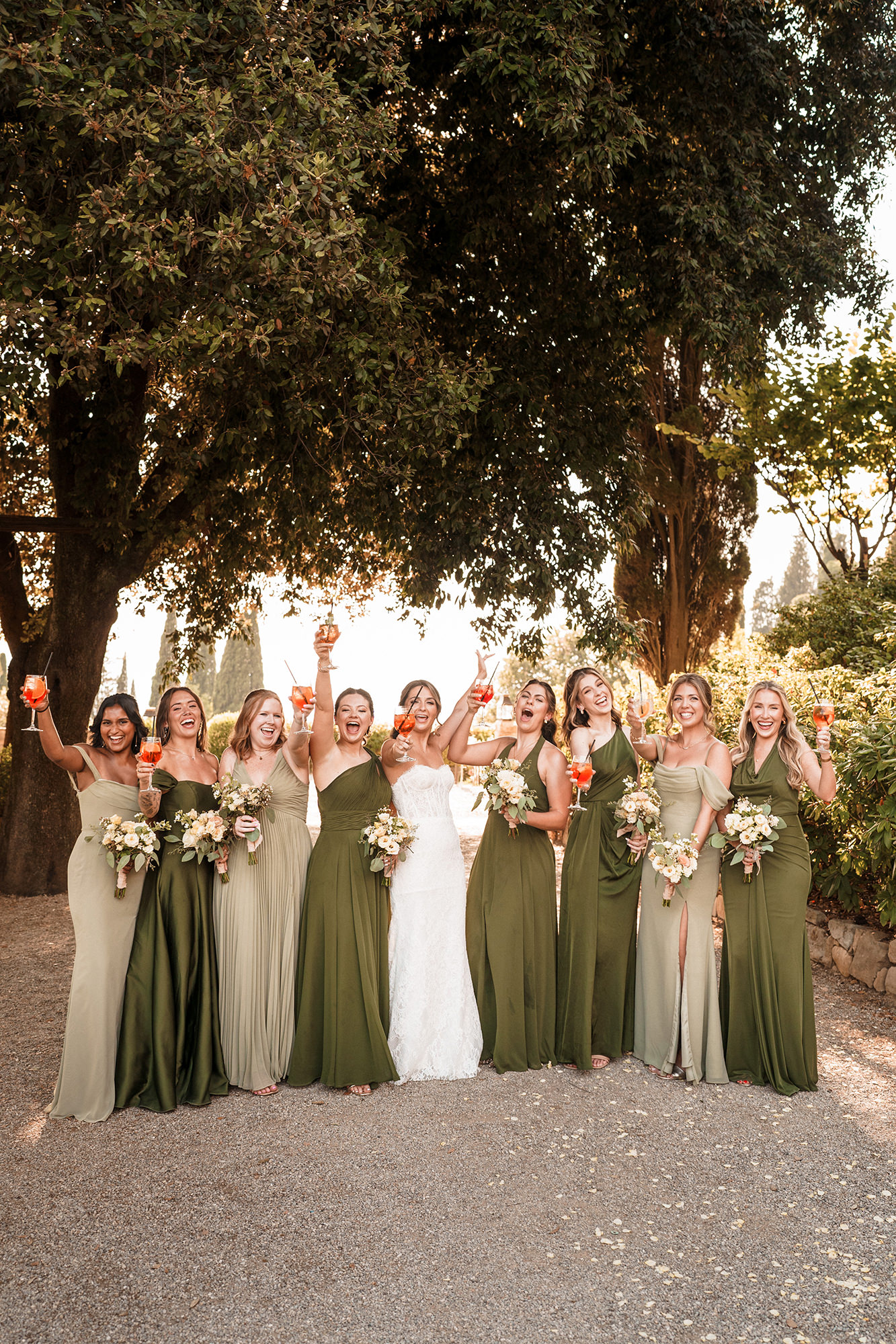 Bride celebrating with her bridesmaids outdoors at a wedding in France
